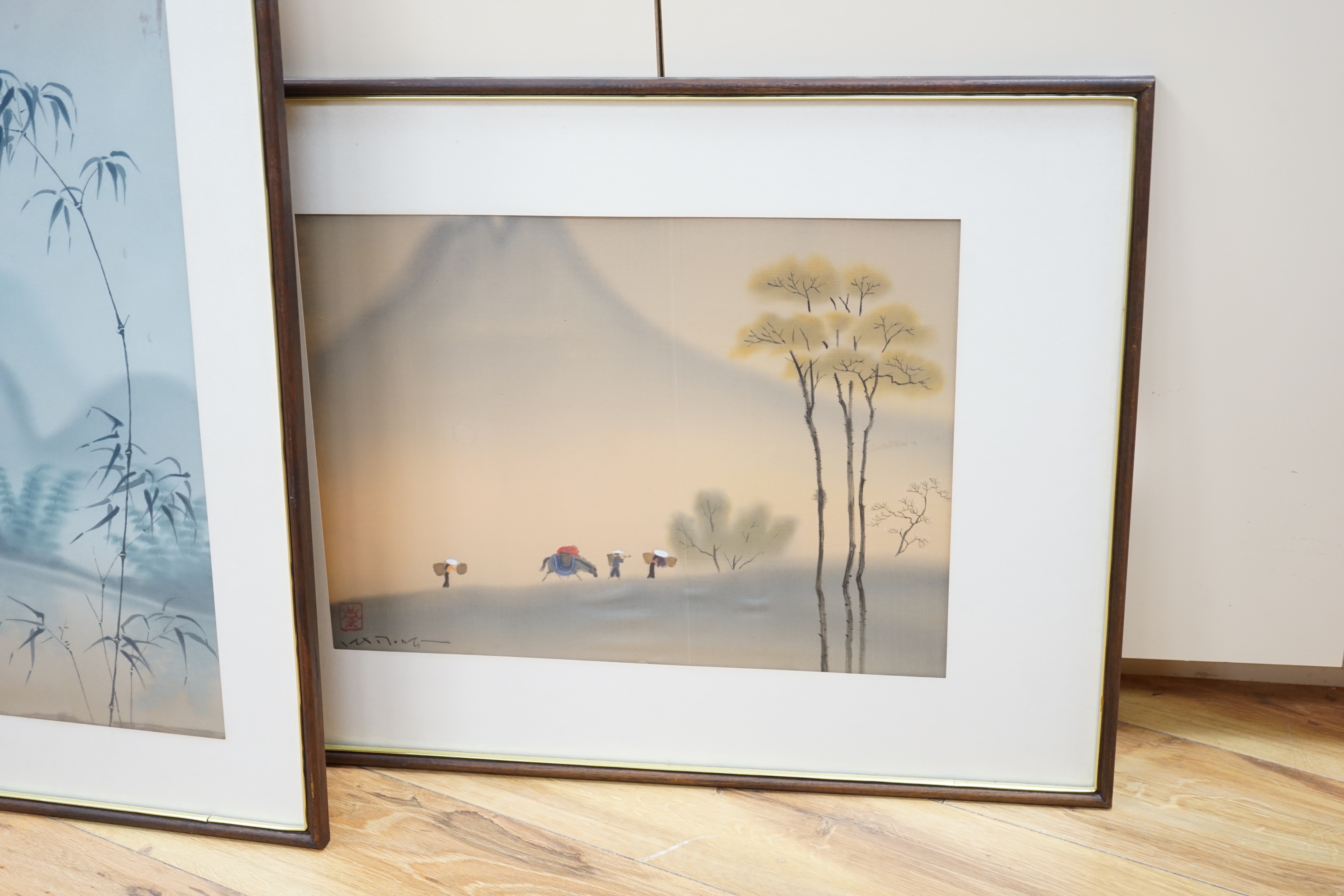 Four 20th century Vietnamese watercolour paintings on silk depicting street scene, lake scene and rice planting, all signed, largest 56 x 36cm, glazed frames
